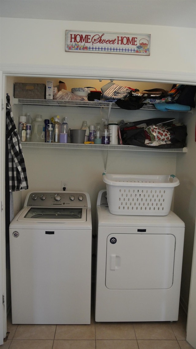 laundry area featuring light tile patterned floors, laundry area, and independent washer and dryer