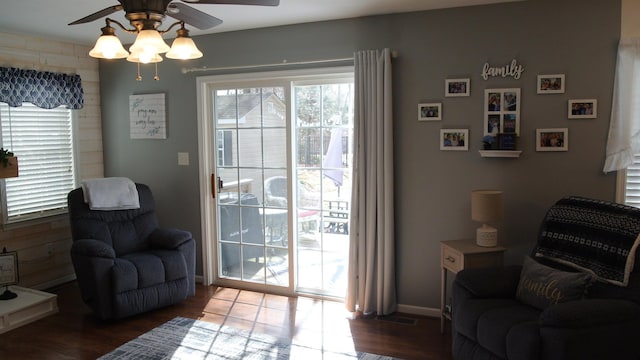 sitting room with visible vents, ceiling fan, and wood finished floors