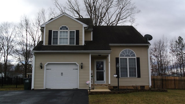 view of front of property with a garage, entry steps, fence, and aphalt driveway