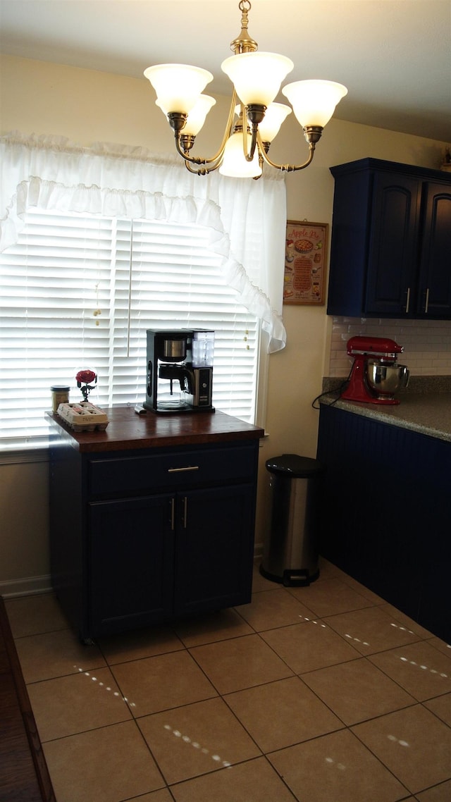 kitchen featuring a chandelier, tasteful backsplash, and light tile patterned flooring