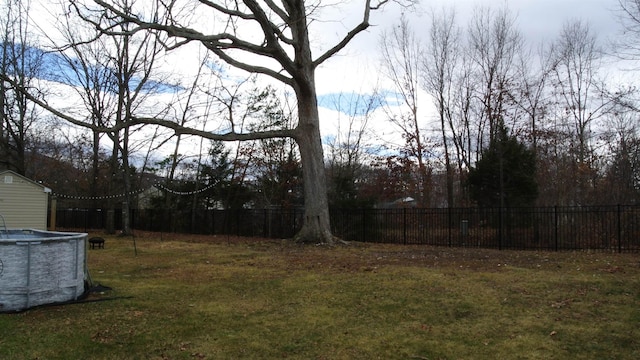 view of yard with fence and a fenced in pool