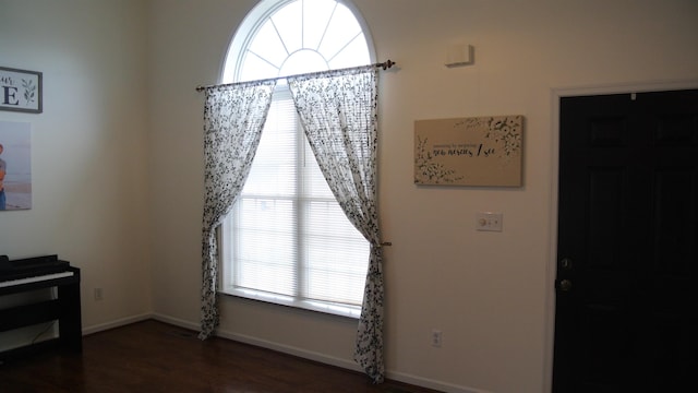 dining space with baseboards and wood finished floors