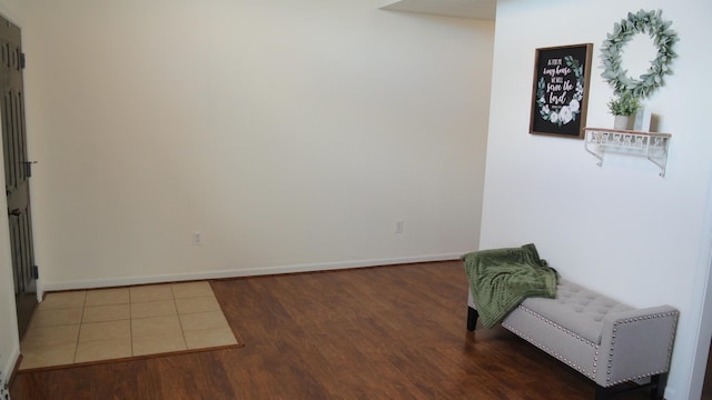 sitting room featuring baseboards and wood finished floors