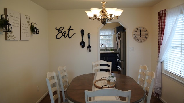 dining room featuring baseboards and a chandelier