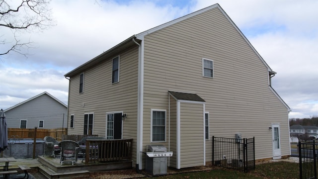 rear view of property with fence