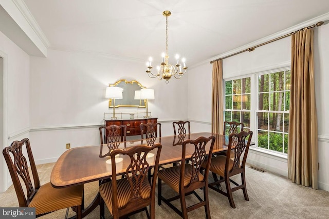 dining area featuring crown molding, light carpet, a chandelier, and baseboards