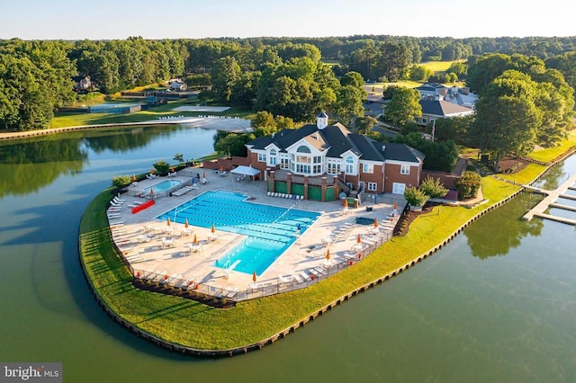 view from above of property featuring a pool area and a large body of water
