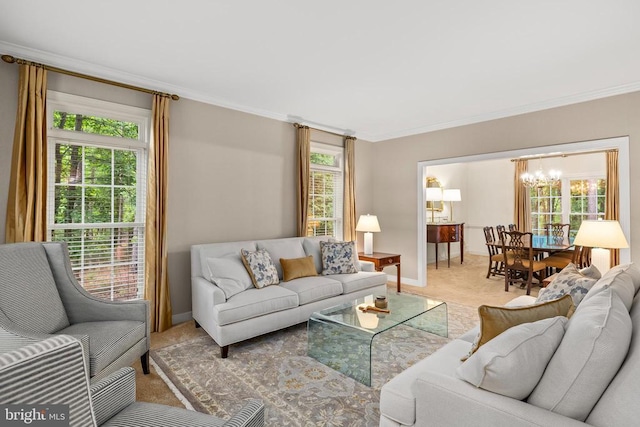 carpeted living area with ornamental molding, a chandelier, and baseboards