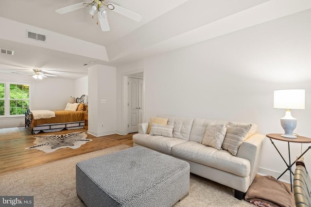 living room featuring ceiling fan, wood finished floors, and baseboards