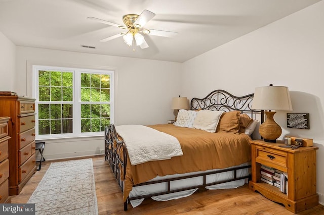 bedroom featuring light wood finished floors and a ceiling fan