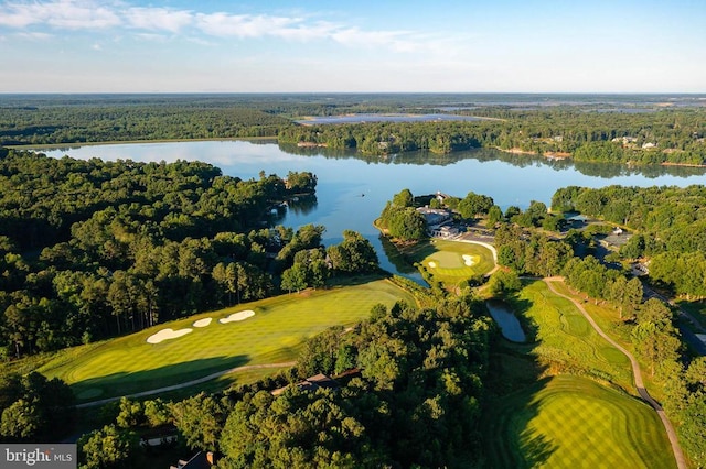 aerial view of property's location with a nearby body of water, a heavily wooded area, and a golf club
