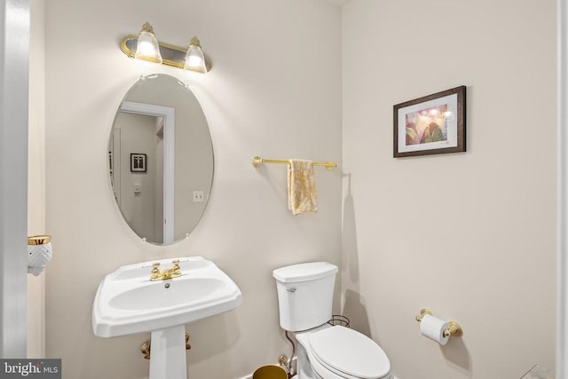 bathroom featuring toilet and a sink