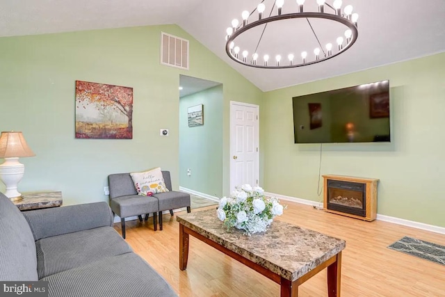 4 Brumback Ave, Luray, VA 22835 - living area featuring wood finished floors, lofted ceiling, a chandelier, and a fireplace
