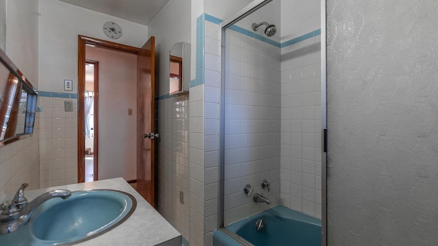 338 Fairfax Ave, Elkton, VA 22827 - bathroom featuring combined bath / shower with glass door, tile walls, and vanity