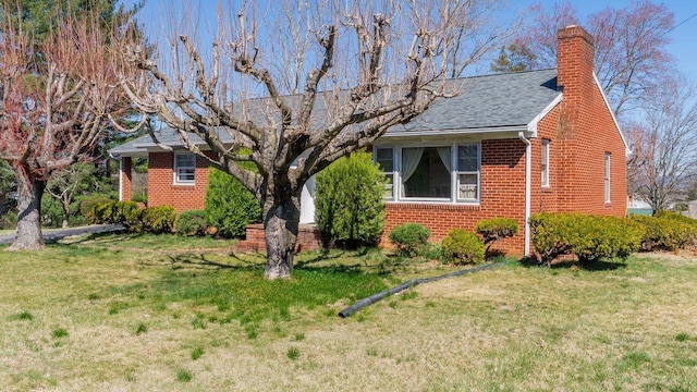 338 Fairfax Ave, Elkton, VA 22827 - view of front facade with brick siding, a front yard, and roof with shingles