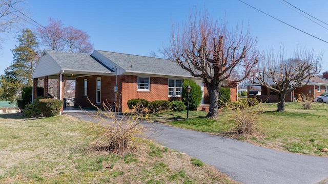 338 Fairfax Ave, Elkton, VA 22827 - ranch-style house featuring driveway, brick siding, a front yard, a carport, and roof with shingles