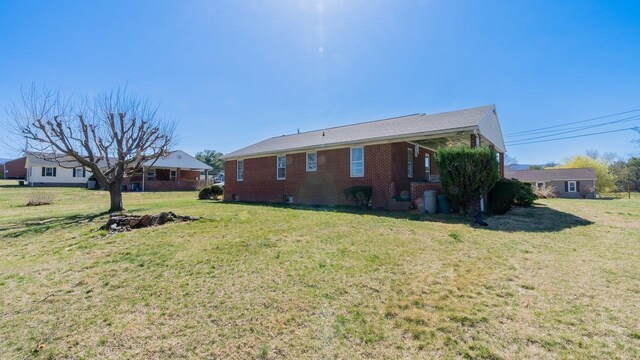 338 Fairfax Ave, Elkton, VA 22827 - view of home's exterior with a lawn and brick siding