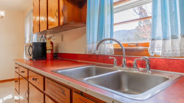 338 Fairfax Ave, Elkton, VA 22827 - kitchen featuring a sink, black microwave, and brown cabinetry