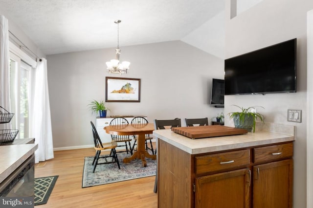11608 Brian Dr, Fredericksburg, VA 22407 - dining area featuring light wood finished floors, a chandelier, baseboards, and vaulted ceiling