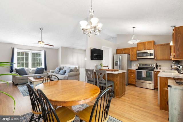 11608 Brian Dr, Fredericksburg, VA 22407 - dining area with lofted ceiling, light wood-type flooring, a ceiling fan, and a chandelier