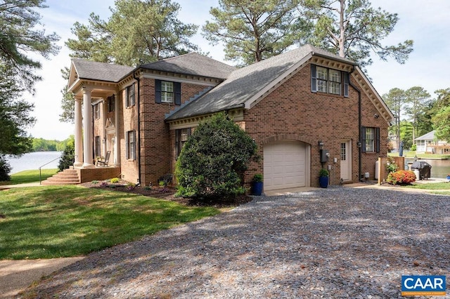 25 Bolling Cir, Palmyra, VA 22963 - view of front of property featuring gravel driveway, brick siding, a front yard, an attached garage, and roof with shingles