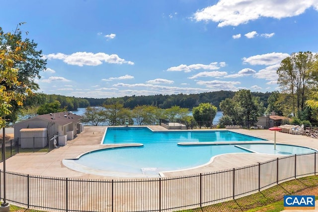25 Bolling Cir, Palmyra, VA 22963 - community pool with fence, a patio area, and a view of trees
