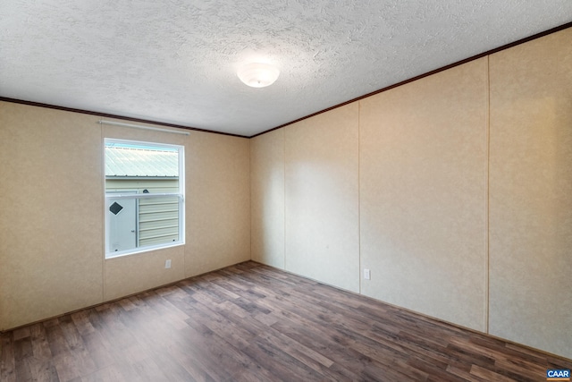 unfurnished room with ornamental molding, a textured ceiling, and wood finished floors