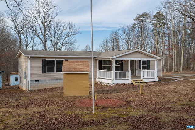 view of front of house with a shingled roof, covered porch, and crawl space