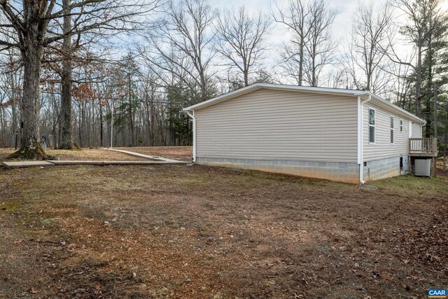 view of side of property with central air condition unit and crawl space