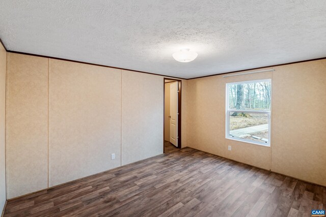 unfurnished bedroom featuring a textured ceiling and wood finished floors