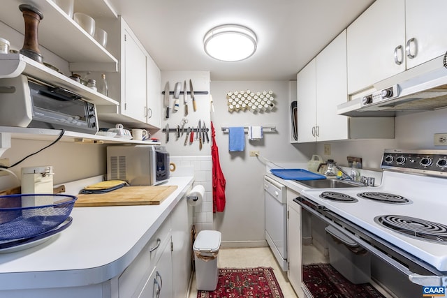 kitchen featuring white appliances, under cabinet range hood, white cabinetry, light countertops, and baseboards
