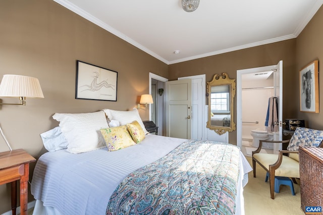 carpeted bedroom featuring ensuite bath and crown molding