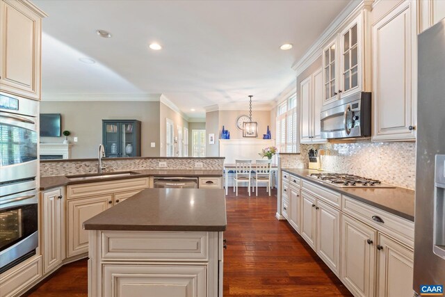 1664 Wickham Way, Charlottesville, VA 22901 - kitchen with stainless steel appliances, a sink, crown molding, dark countertops, and cream cabinetry
