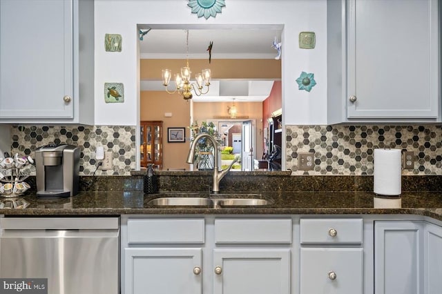 kitchen featuring stainless steel dishwasher, a sink, ornamental molding, backsplash, and dark stone counters