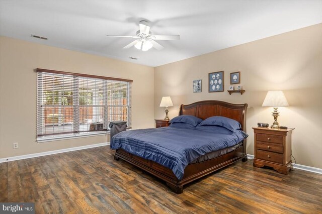 bedroom featuring wood finished floors, baseboards, and a ceiling fan