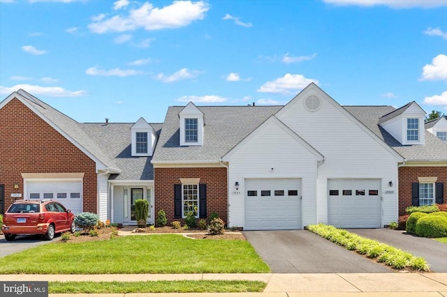 view of front of house with brick siding, a front yard, a garage, and roof with shingles