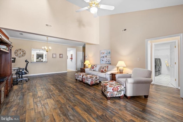 living room with high vaulted ceiling, a chandelier, a ceiling fan, washer / clothes dryer, and wood finished floors
