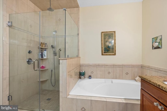 full bathroom with a garden tub, a stall shower, and vanity