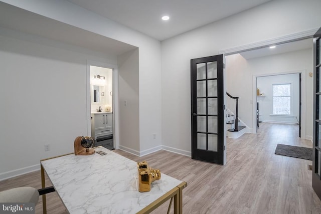 office area with light wood-style flooring, baseboards, and recessed lighting