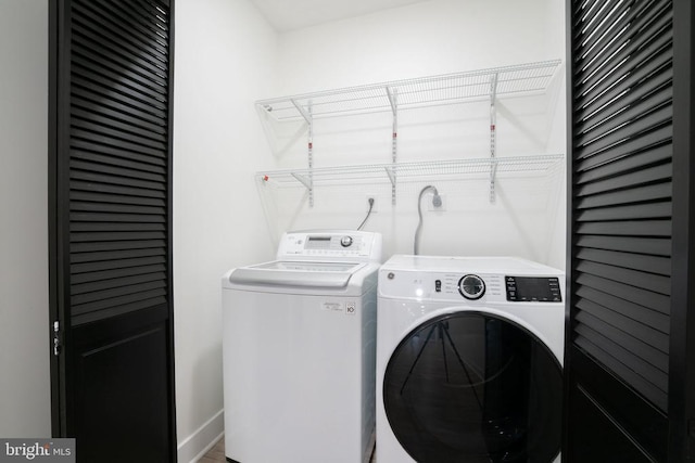 clothes washing area featuring independent washer and dryer