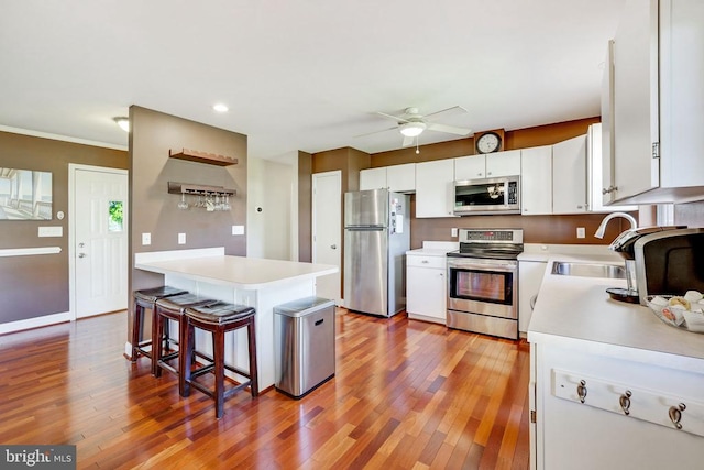 15605 Cedar Tree Ct, Mineral, VA 23117 - kitchen featuring stainless steel appliances, light countertops, a ceiling fan, light wood-style floors, and a kitchen breakfast bar