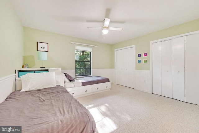 15605 Cedar Tree Ct, Mineral, VA 23117 - carpeted bedroom featuring a wainscoted wall, two closets, and a ceiling fan