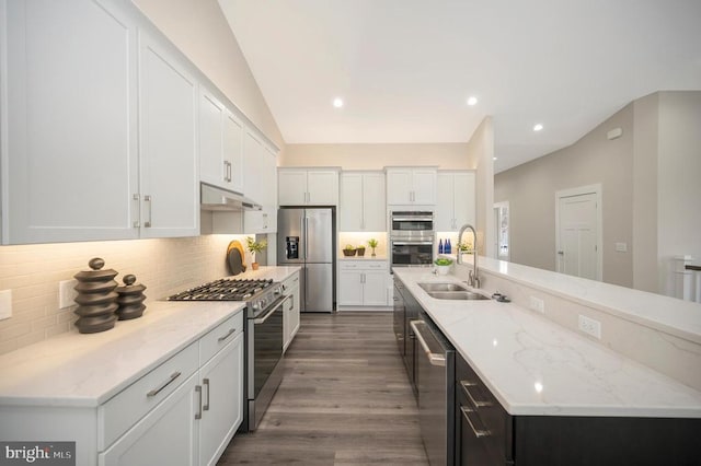 573 Sunset Loop, Mineral, VA 23117 - kitchen with appliances with stainless steel finishes, under cabinet range hood, white cabinets, a spacious island, and backsplash