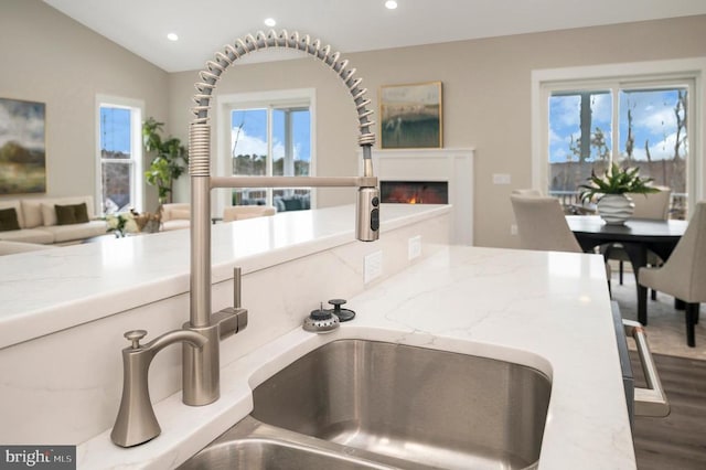 573 Sunset Loop, Mineral, VA 23117 - kitchen featuring open floor plan, a glass covered fireplace, recessed lighting, healthy amount of natural light, and light stone counters
