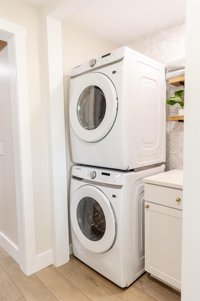 519 Arpia St, Lexington, VA 24450 - laundry room with stacked washer and clothes dryer, cabinet space, and light wood-style flooring