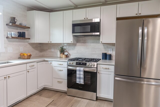 519 Arpia St, Lexington, VA 24450 - kitchen with appliances with stainless steel finishes, light countertops, white cabinets, and tasteful backsplash