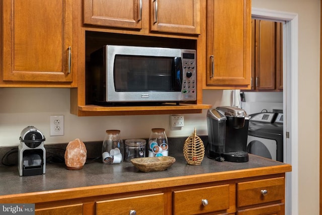 6005 Page Valley Rd, Luray, VA 22835 - kitchen featuring stainless steel microwave, washer / dryer, dark countertops, and brown cabinets