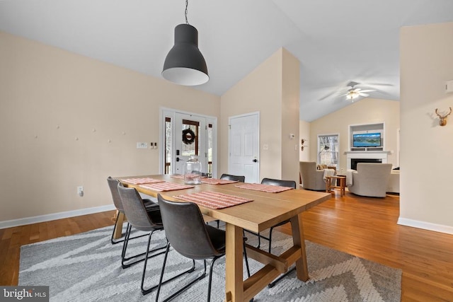 6005 Page Valley Rd, Luray, VA 22835 - dining space featuring lofted ceiling, a ceiling fan, a fireplace, wood finished floors, and baseboards