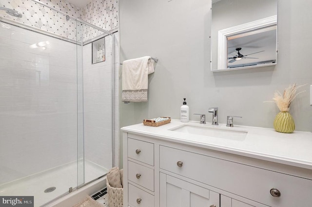 bathroom with a stall shower, a ceiling fan, and vanity