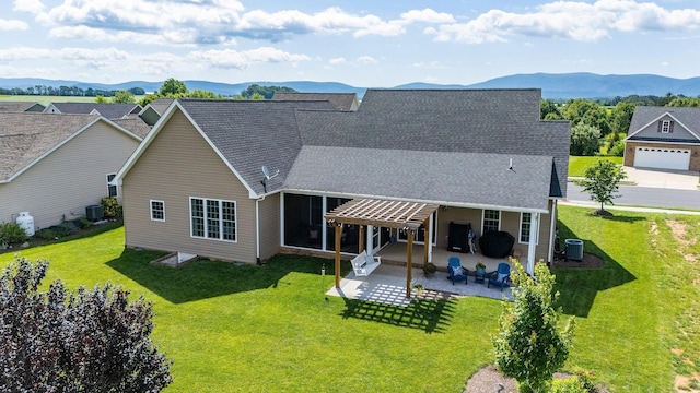 193 Locust Grove Ln, Stuarts Draft, VA 24477 - rear view of property featuring a patio area, a mountain view, a lawn, and roof with shingles